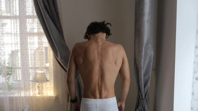 curved spine in a man, scoliosis of the spine.