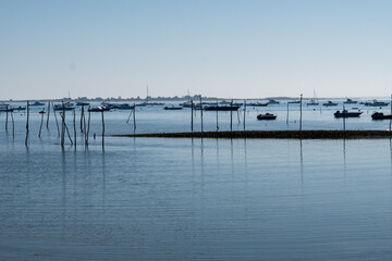 View on Arcachon Bay at low tide with many fisherman's boats and oysters farms, Cap Ferret...