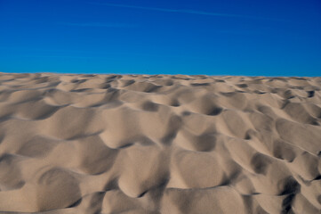 Fototapeta premium Golden sand and blue sky, Dune of Pilat tallest sand dune in Europe located in La Teste-de-Buch in Arcachon Bay, France southwest of Bordeaux along France's Atlantic coastline