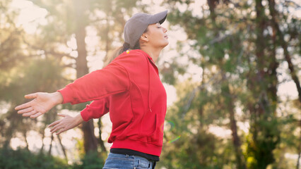 Woman arms outstretched in nature