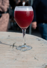 Famous fresh brewed red lambic kriek cherry beer served outside in Belgian beer festival in Durbuy,...