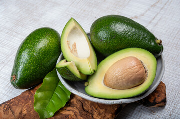 Green ripe avocado fruits from organic avocado plantation - healthy food - obrazy, fototapety, plakaty