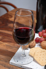 Red porto and cheese pairing, blue matured stilton English cheese served as dessert with walnuts and glass ruby porto wine