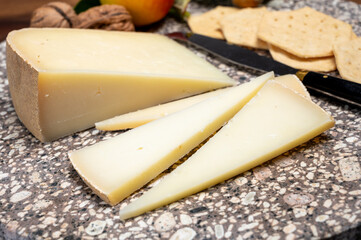 Piece of tasty Ossau-Iraty or Esquirrou sheep cheese produced in south-western France, Northern Basque Country