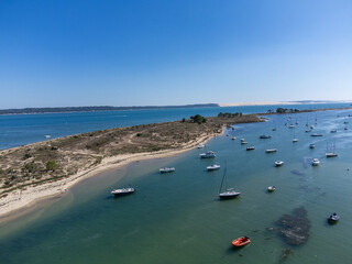 Aerial view on Arcachon Bay with many fisherman's boats and oysters farms near Le Phare du Cap Ferret, Cap Ferret peninsula, France, southwest of Bordeaux, France's Atlantic coastline