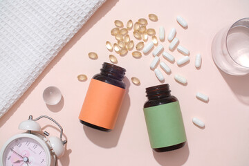 The white pills and vitamin E capsules were poured from two unbranded pill bottles. On the table...
