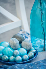Easter still life background. Painted mother-of-pearl marble eggs and willow branches. Photo in...