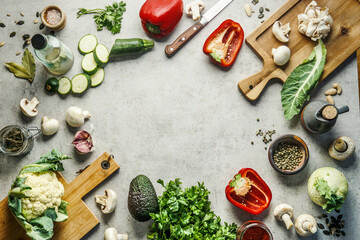Healthy eating and fresh cooking concept. Frame of various herbs and vegetables ingredients, knife...