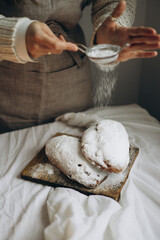 homemade freshly baked Christmas stolen with spiced raisins and nuts festively decorated and sprinkled with powdered sugar
