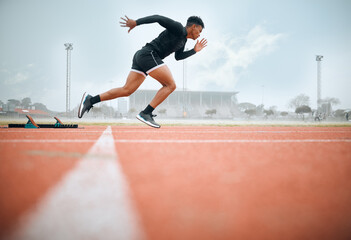 Man, athlete and ready for race on track with practice, training or exercise for competition. Black person, runner and fast with dedication, determination and passion on face with speed for sport - Powered by Adobe