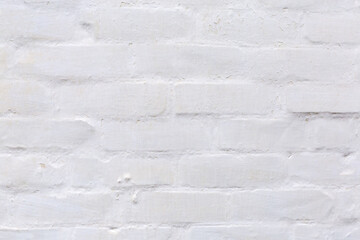 Fragment of the old whitewashed brick wall close-up