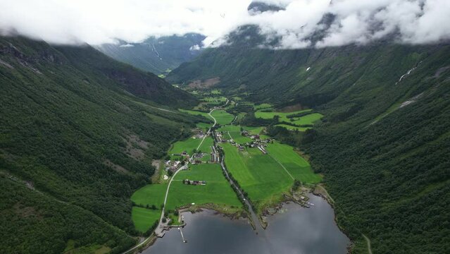 Glacier melt river flowing alongside road in the valley of Fjord in Norway during summer	
