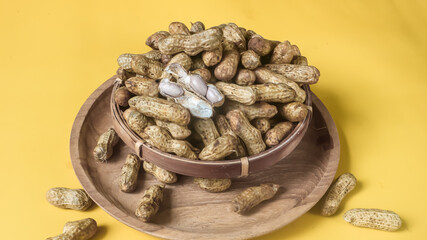 Boiled peanuts isolated on yellow background 