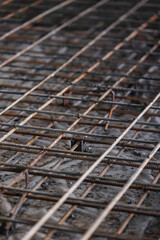 Iron frame for foundation floor, building site, top view. Closeup reinforced concrete structures, knitting of metal reinforcing cage