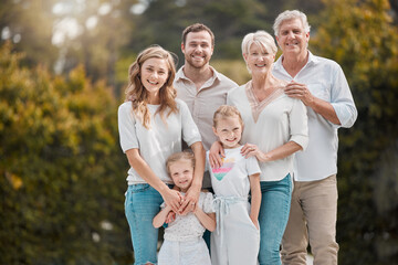 Portrait of big family in garden together with smile, grandparents and parents with kids in...
