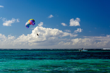 Fototapeta na wymiar Colorful parasail over the turquoise water in Mauritius 