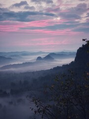 Sunrise Saxon Switzerland with fog and pink clouds