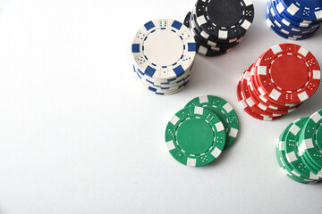 Stacks of colorful casino chips on white isolated table