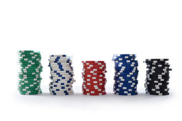 Stacks of colorful casino chips with white isolated background