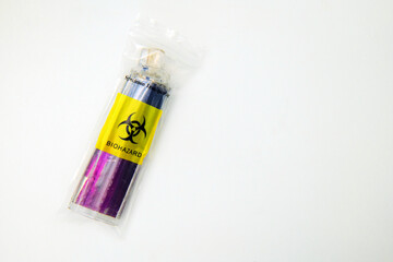 A discarded vibrant purple single use electronic cigarette vape has been placed inside a small...