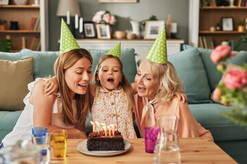 Mother, daughter and grandmother at birthday party at home
