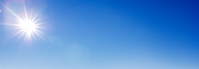 Blue with gradient sky with a sunny halo, copy space - obrazy, fototapety, plakaty