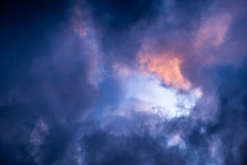 Blue hole in the dark cloudy sky. Storm Clouds. Evening sunset. Rainy and stormy weather. Art wallpaper. Natural landscape. Beauty in nature. After thunderstorm. The hope concept. High quality photo
