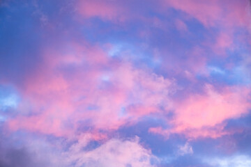 Blue morning sky is in pink clouds. Sunrise clouds are in vanilla colours. Beauty in nature. Twilight time, golden hour. Details of evening sunset. Natural abstraction. Peace concept. Panoramic view