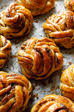 Traditional Swedish cardamom swirl buns - kardemummabullar, focus on the bun inside. Homemade sweet pastries.