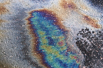 Petrol Oil Pollution Rainbow Gasoline Leak on Pavement.
