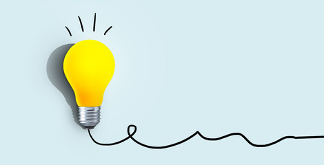 Creative yellow light bulb with shadow burns on a blue background, concept. Think differently, creative idea. Light came on. Brainstorm and thinking. Education and training. Free copy space. Success