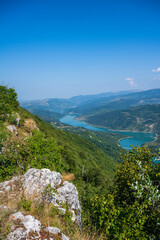 Fototapeta na wymiar The Kozji Kamen viewpoint offers a beautiful view of Lake Zavojsko, the meanders of the Visocica River and mountain peaks. Serbia near Pirot.