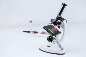 The microscope is on the table. Middle school science laboratory equipment.