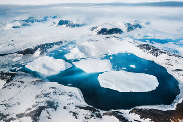 The image shows a stunning aerial view of Jokulsarlon glacier lagoon in Iceland, with icebergs...