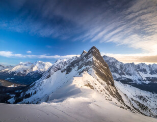 Snow-capped peaks rise majestically against a serene blue sky, creating a breathtaking winter...