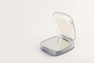 Cosmetic mirror on a white background. Space for text.