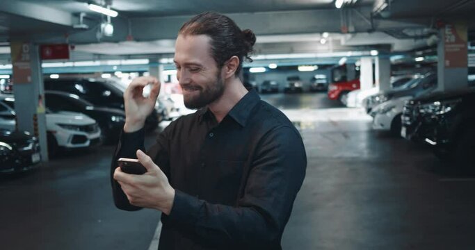 Man looked at message about an important event in his work. Businessman looks at his phone and rejoices after learning about successful outcome of negotiations or deal. Man looks happy and inspired.