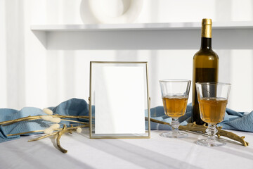 5x7 card mockup in golden frame with wine bottle and glasses