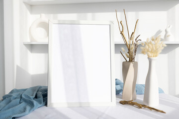 Obraz na płótnie Canvas White photo frame mockup with beige vase