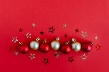 Beautiful Christmas ornaments on a bright red background with stars.