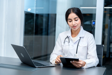 Professional Indian female doctor in consultation with a patient through a digital tablet. Concept of telemedicine and healthcare technology. Young woman physician providing medical advice remotely.