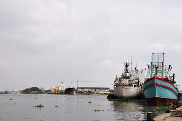 Fishery boat ship and General cargo vessel floating in water waiting catch fish marine life in...