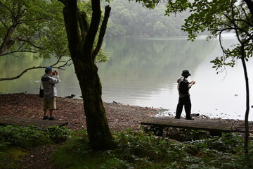湖の写真を撮る人　自然　森　山　湖畔　写真撮影　後ろ姿