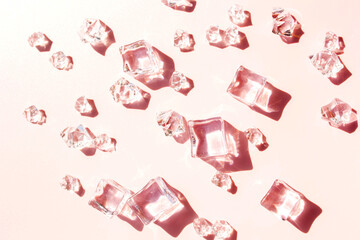 Ice cubes on a pink background. View from above