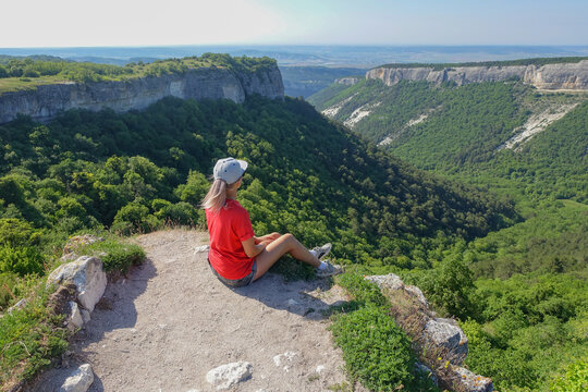 Mangup-Kale cave city, sunny day. A girl on the background of a mountain view from the ancient cave city of Mangup-Kale in the Republic of Crimea, Russia. Bakhchisarai.