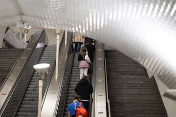 Escalator of metro - woman in short skirt riding up