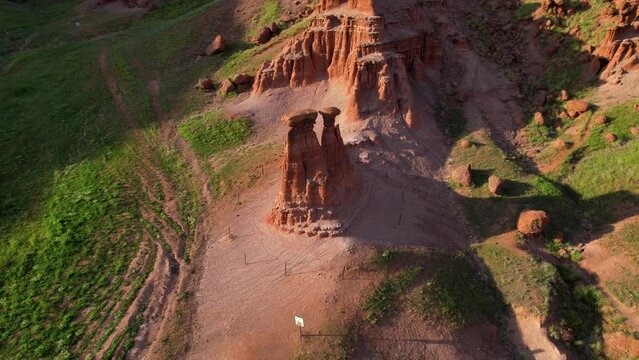 erzurum narman fairy chimneys green grass on red soil aerial view 4K