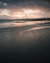 A stunning windy beach sunset at low tide