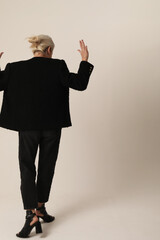 Vertical portrait of woman doing hands gesture posing on white background.