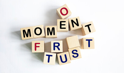Moment of truth text on wooden blocks and light background